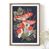 A framed art print featuring a colourful illustration of fly agaric mushrooms and woodland foliage.