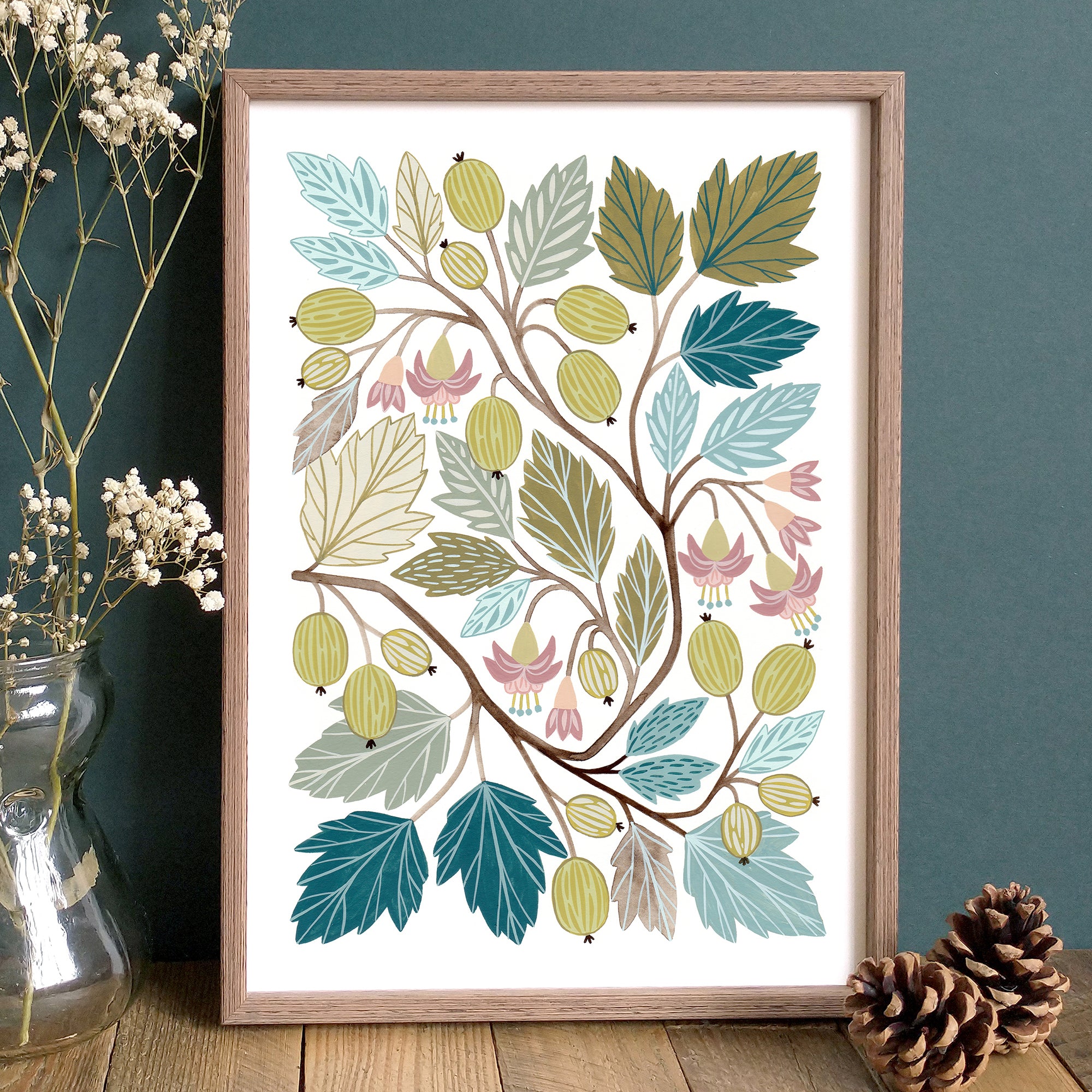 A framed botanical art print featuring gooseberries, leaves and flowers in greens, teal and olive tones.