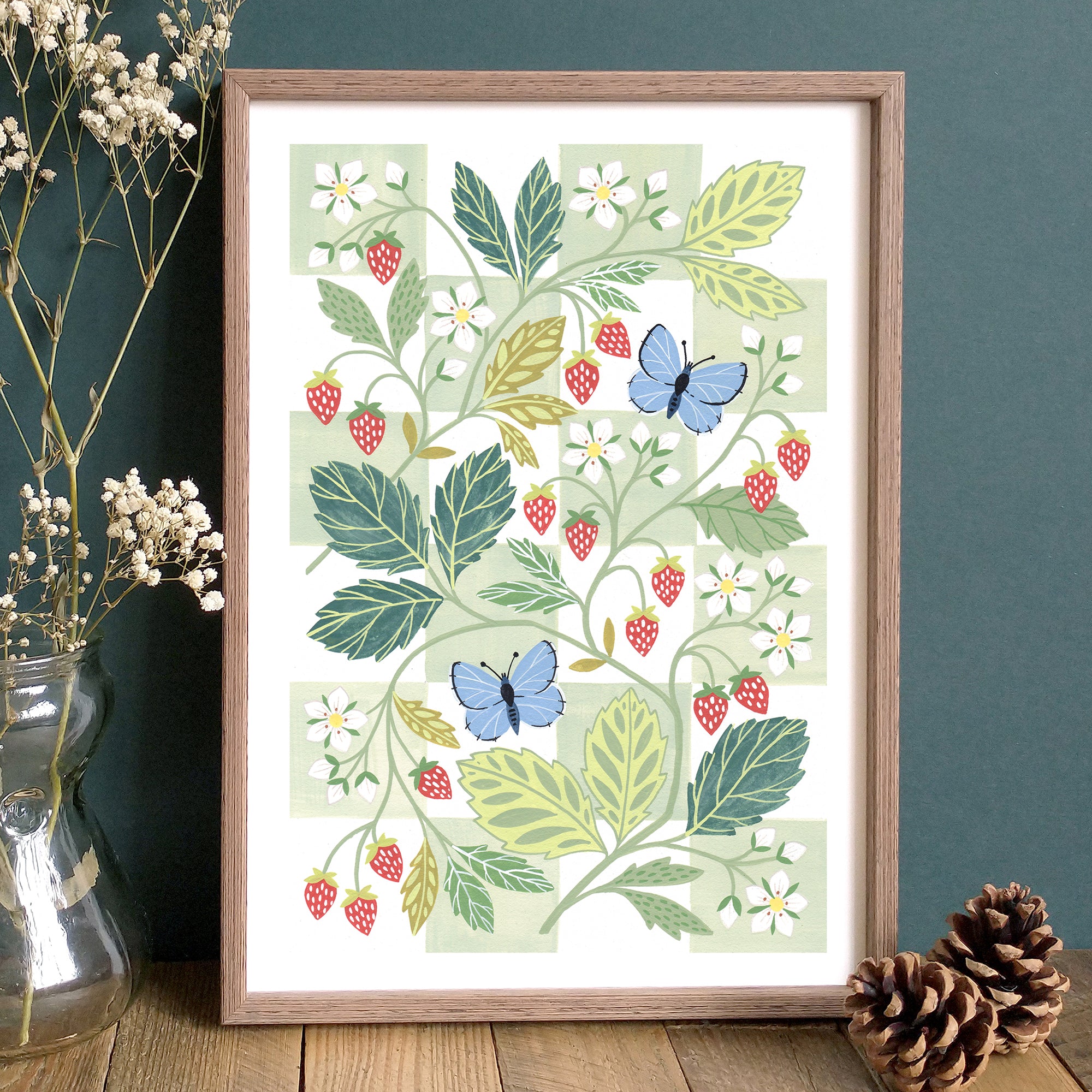 A framed art print of wild strawberries with common blue butterflies.