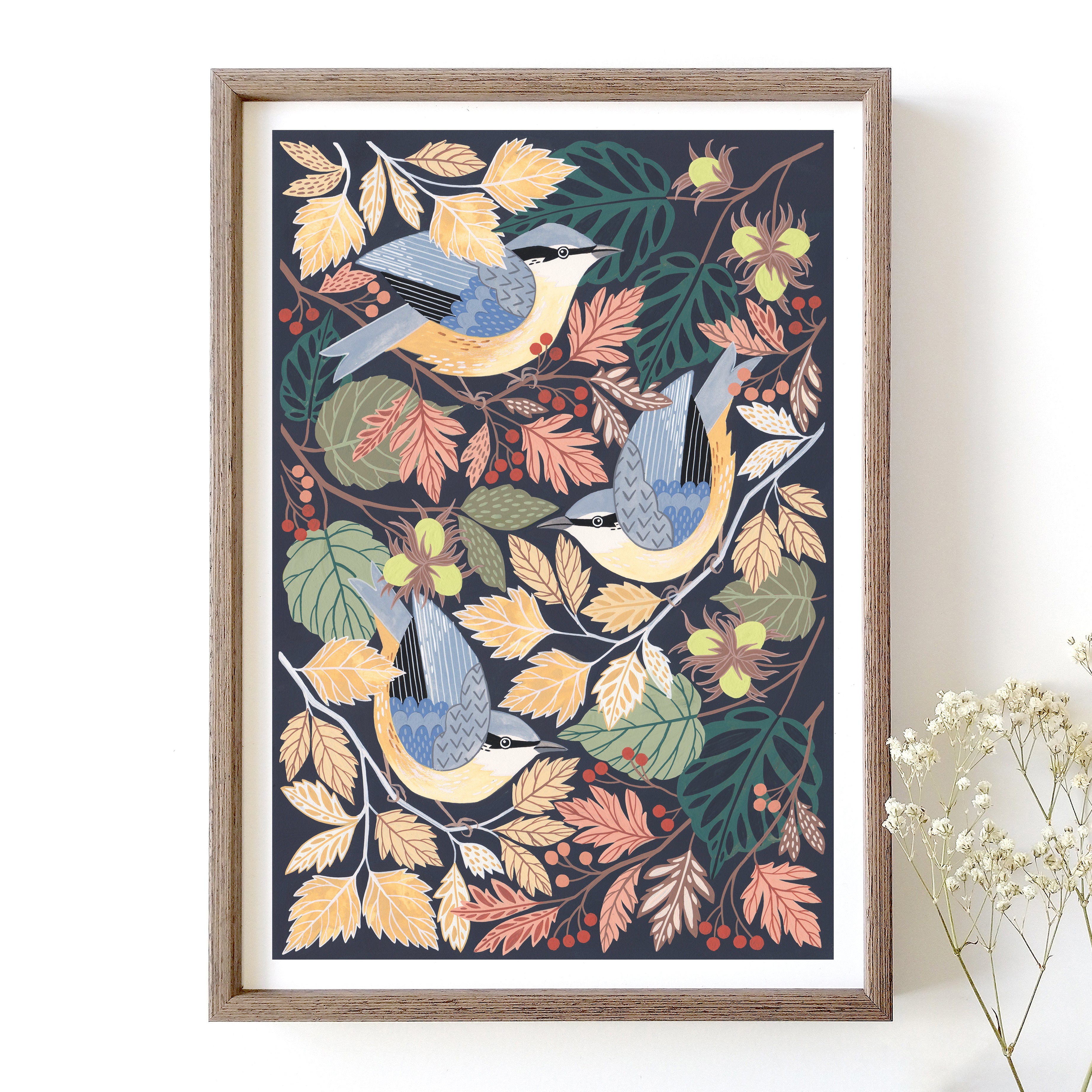 Framed artwork with nuthatches and autumn leaves on a dark blue background