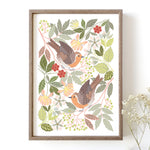 Framed robin artwork with woodland foliage on a white background