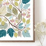 A framed botanical art print featuring gooseberries and leaves in muted teal, sage, olive, pink, and brown tones on a white background.
