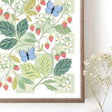 Framed botanical wall art print with strawberries and blue butterflies against a white and green chequerboard background.